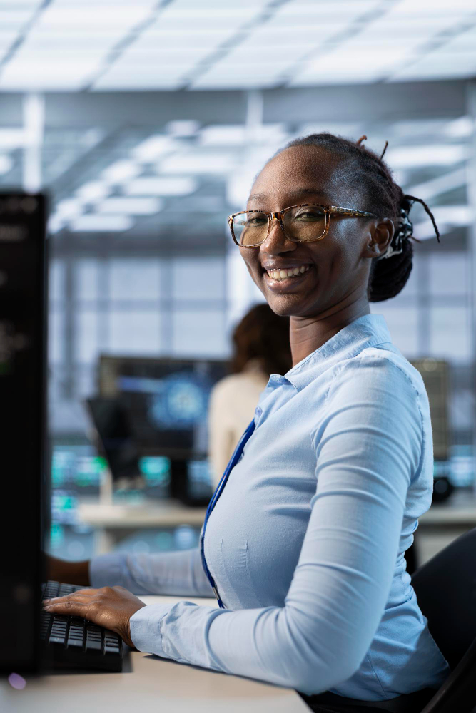 Professional smiling at a computer